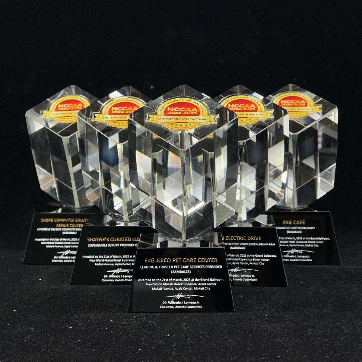 Set of crystal awards with black stands on a dark background