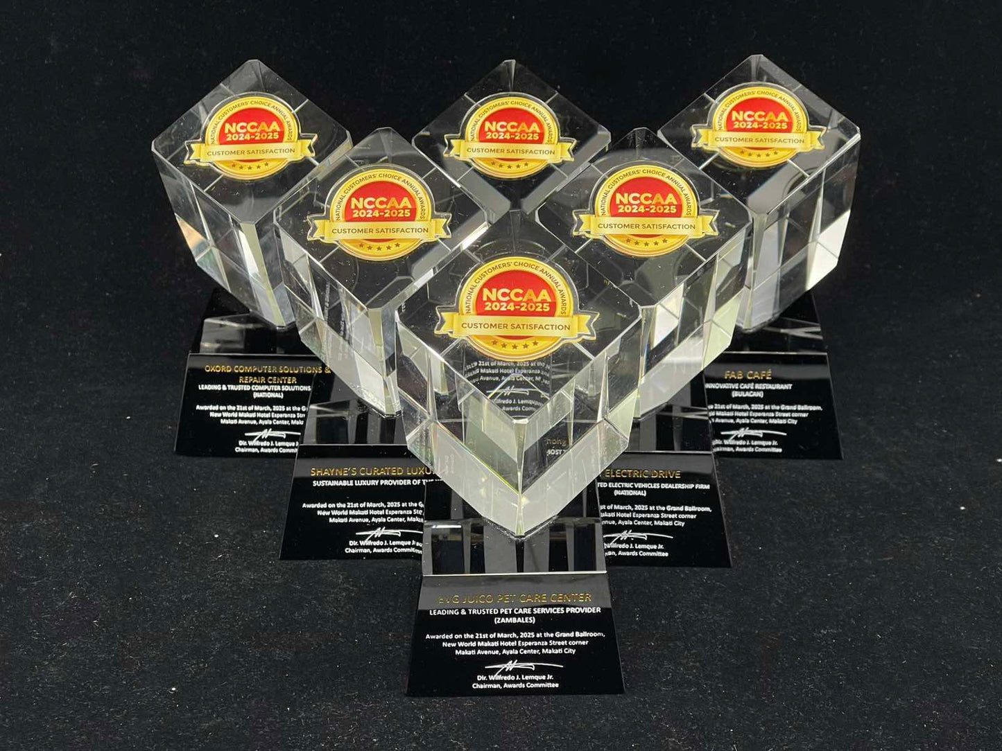 Set of clear awards with NCCAA logo on a black background