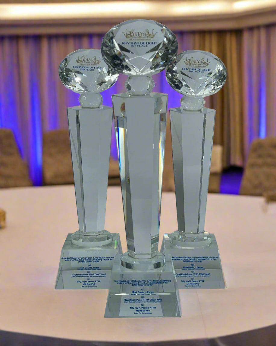 Three crystal awards on stands with visible branding against a white background