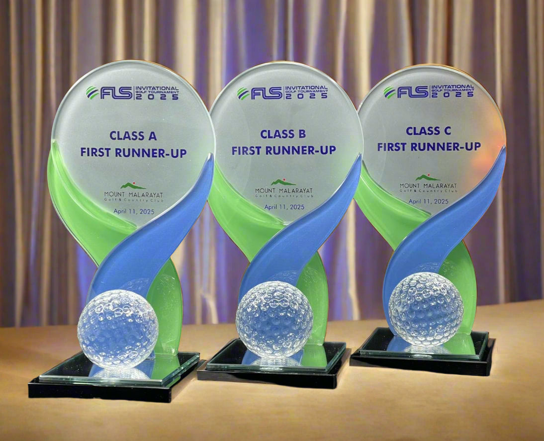 Three identical trophies with blue and green design, featuring 'FLS Events' branding, on a dark background.