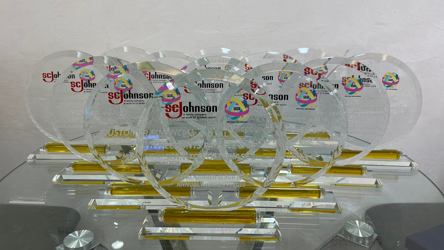 Collection of glass awards with 'Sc Johnson' branding on a white background