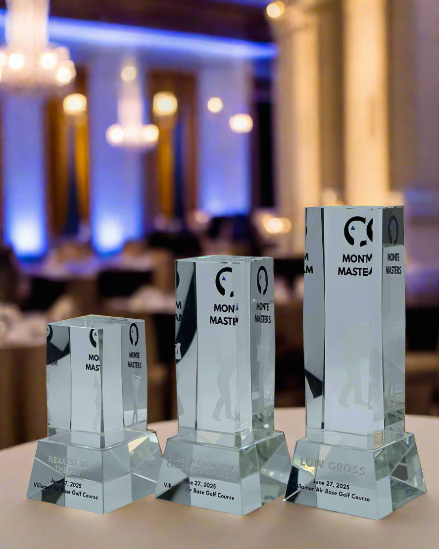 Set of crystal awards with engraved text on a light gray background