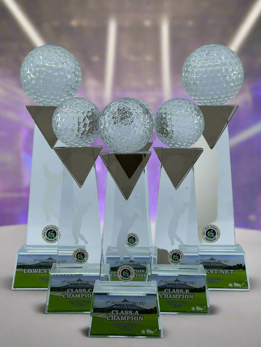 Set of five golf trophy awards with crystal balls on a white background