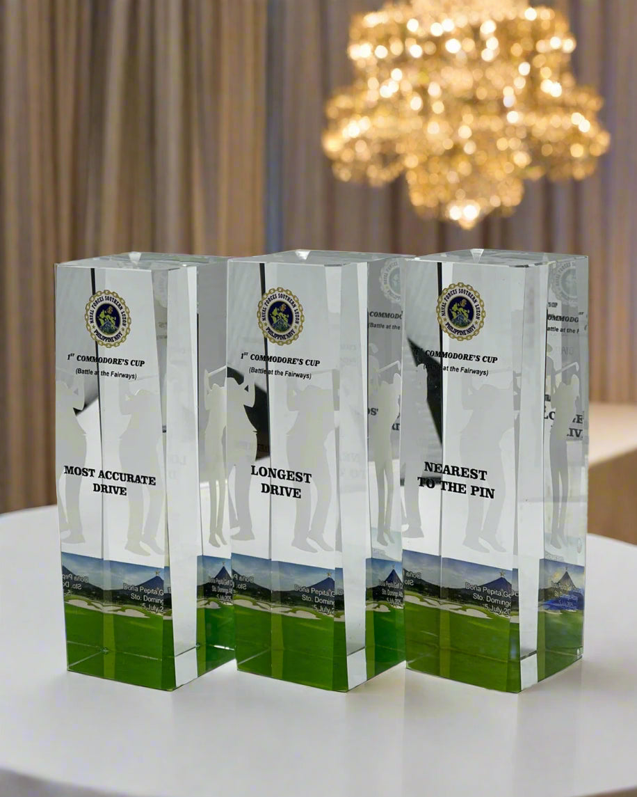 Three crystal awards for a golf tournament on a white background