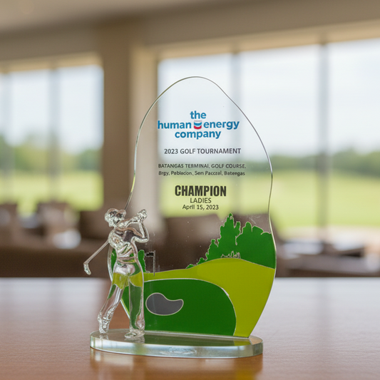 Golf tournament trophy with a golfer on a green course design, featuring the 'human energy company' branding.