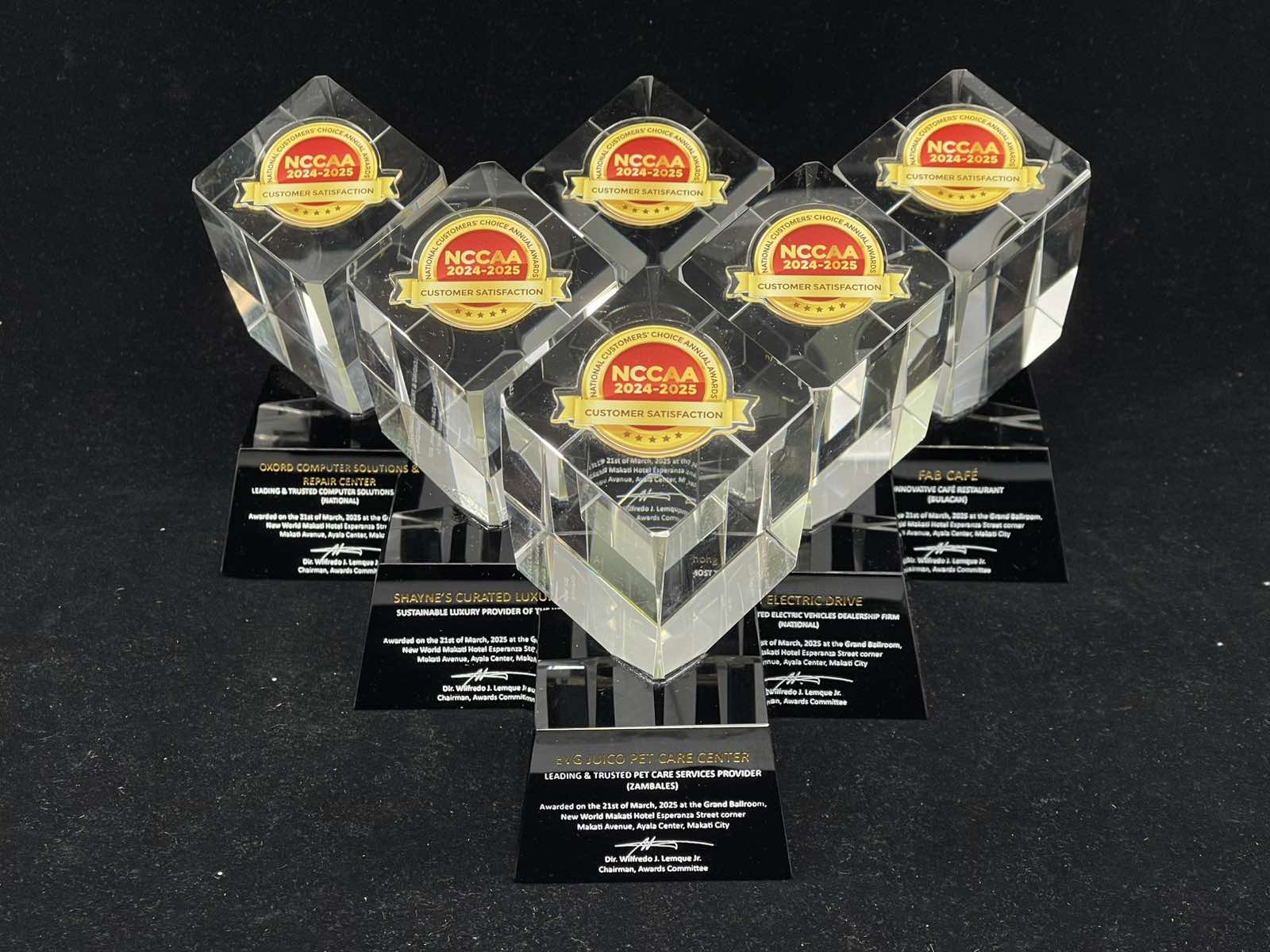 Set of clear awards with NCCAA logo on a black background