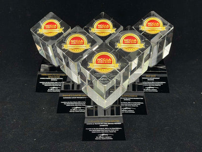 Set of clear awards with NCCAA logo on a black background