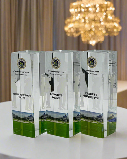 Three crystal awards for a golf tournament on a white background
